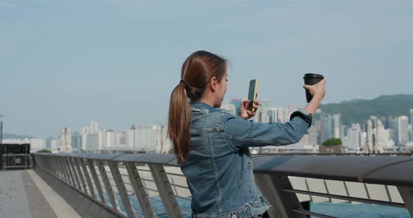 Woman Hold a Cup of Coffee and Use of Mobile Phone to Take Photo