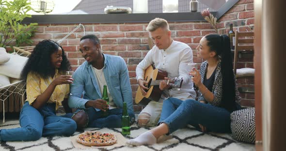 Mixed Race Youth which Having Fun Together During Summer Friends Party on the Balcony