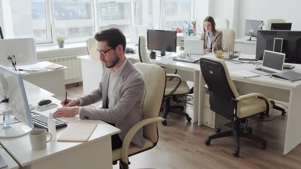 Businesspeople Working in Office during Covid-19 Pandemic