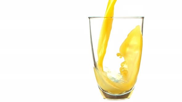 Super Slow Motion Shot of Pouring Fresh Orange Juice Into Glass at 1000 Fps