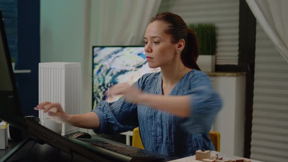 Architect Working on Building Model with Maquette