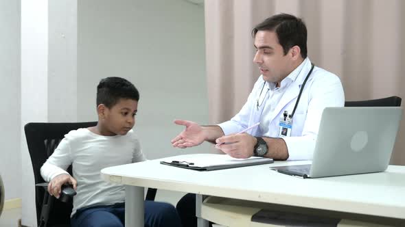 A doctor at an international hospital Trying to check up of a mischievous child in the hospital's OP