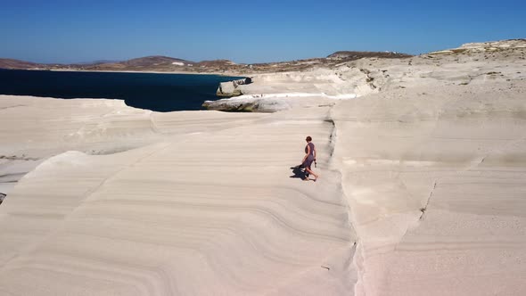 Female tourist exploring Sarakiniko beach, Milos island, Greece
