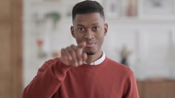 Portrait of African Man Pointing towards Camera and Inviting