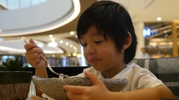 Cute Asian Child Eating Japanese Noodles In A Restaurant Slow Motion