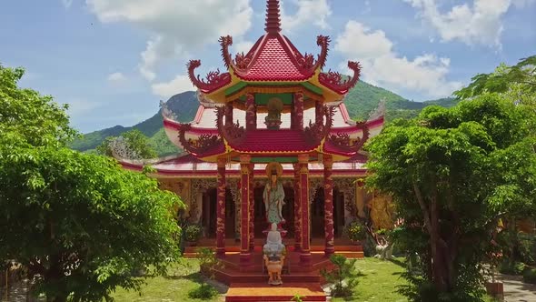 Drone Moves To Temple Pagoda Pavilion Against Hills Sky