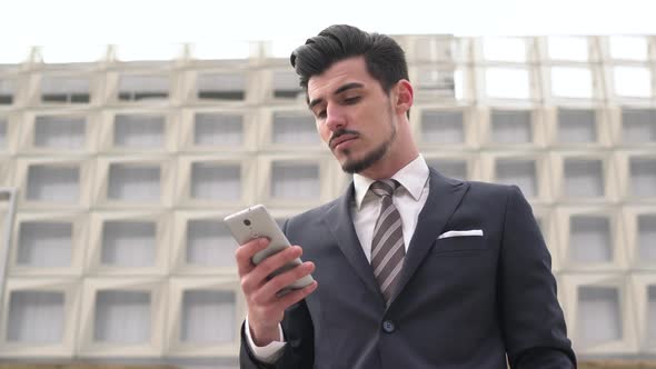 Businessman looking at his mobile phone