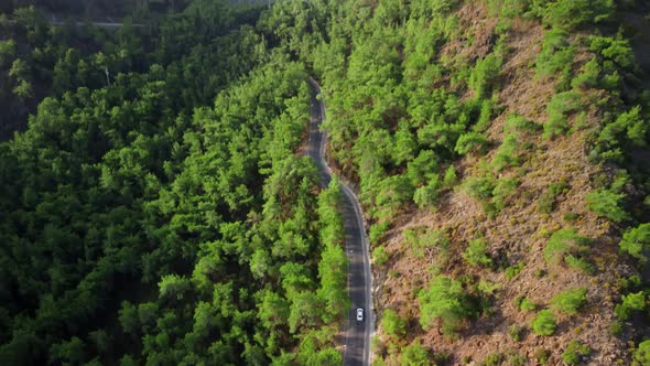 Aerial Footage of Auto Way in Mountains and Riding Cars on It at Warm Summer Day