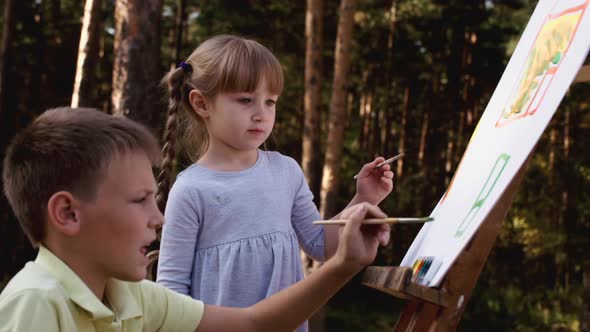 Happy Family Young Parents Drawing Coloring Picture with Brush Helping Cute Child Daughter Enjoying