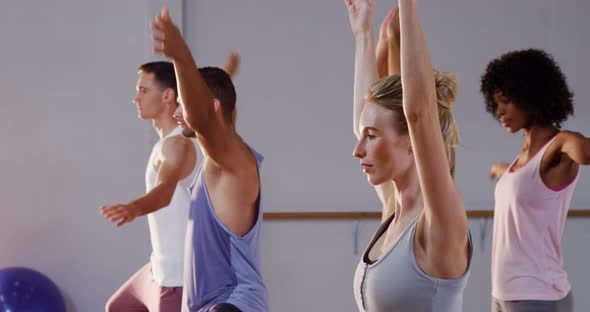 Group of people Practicing yoga in fitness studio