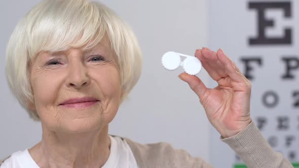 Smiling Aged Woman Showing Contact Lens, Patient Recommendation, Vision Problems