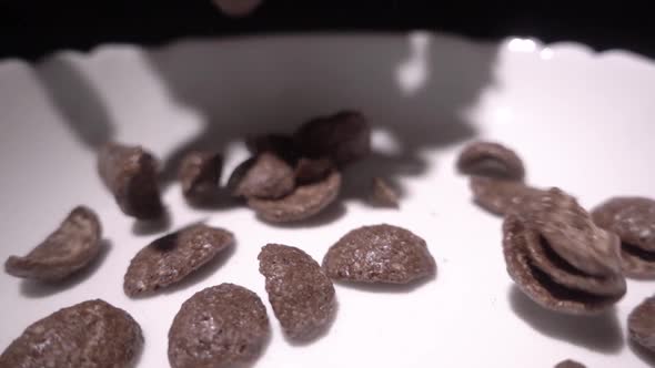 Brown Chocolate Corn Flakes Fall in a White Plate