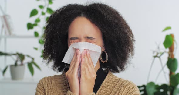 Portrait of Afro American Woman Girl Teenager Suffering From Allergy Symptoms Wipes Nose with White