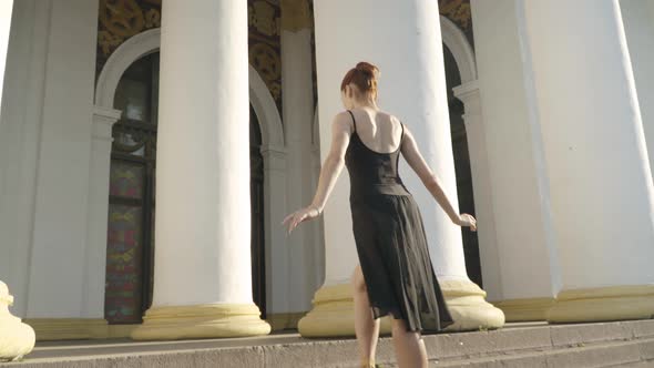 Wide Shot of Elegant Slim Ballerina Walking on Tiptoes Up Urban Stairs