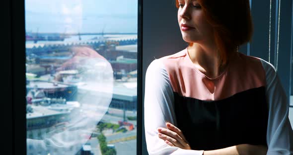 Female executive with arms crossed in office