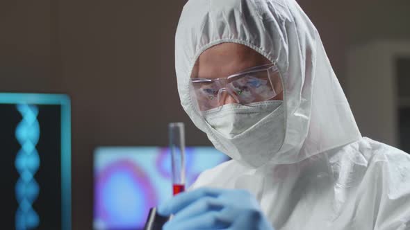 Doctor In Protective Suit Is Doing A Science Experiments And Developing Vaccine In A Modern Lab