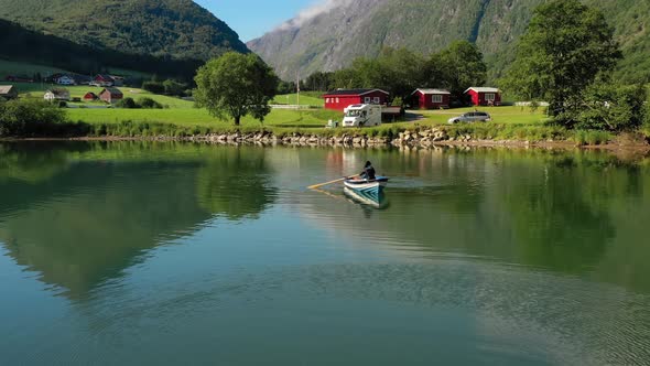 Woman on the Boat Catches a Fish on Spinning in Norway