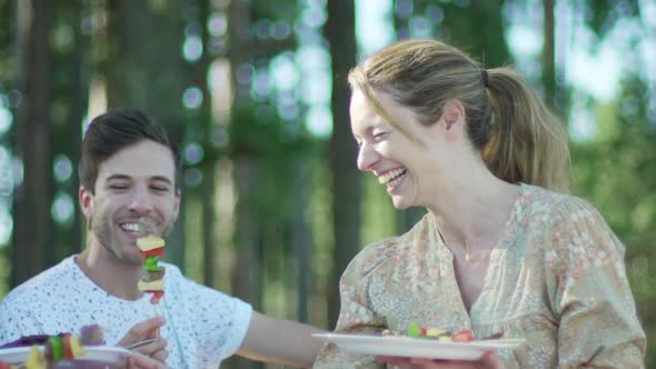 Couple having kebabs together