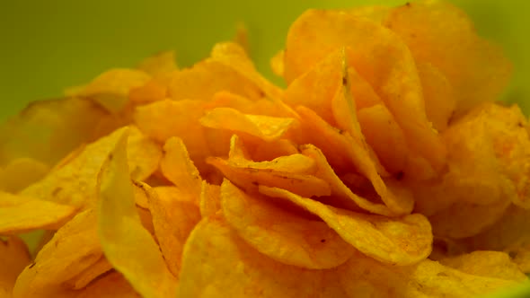 Potato Chips Fall in Green Bowl Rotate Table Fried Potato Chips Close Up