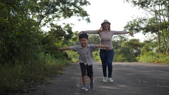 Slow motion, Mother and her son running in the street