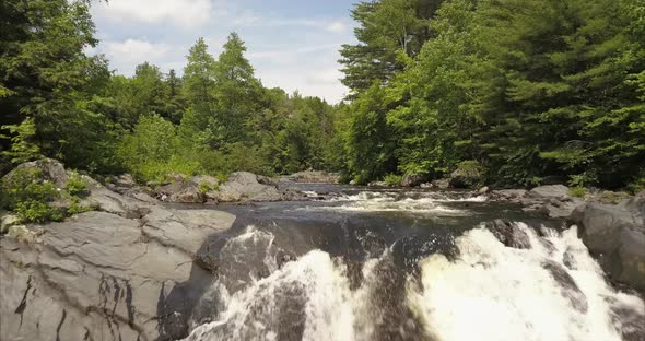 Flying upstream over a waterfall at Tobey Falls in Willimantic, Maine.