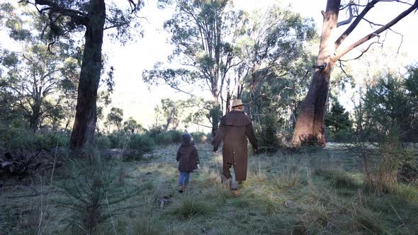 A bushman and his son walk through the bush on a cold morning in the Australian high country.