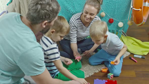 Mom, Dad and Kids Playing with Colorful Clay