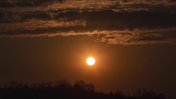 Time lapse amazing sunset with floating clouds going to darkness