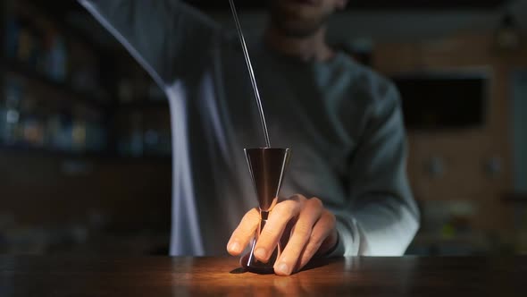 Cinemagraph of Bartender Pours Whiskey To the Jigger in Slow Motion, Making of Alcohol Drink