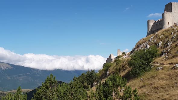 Pan right of Rocca Calascio montaintop fortress and Appenines mountain range, Italy