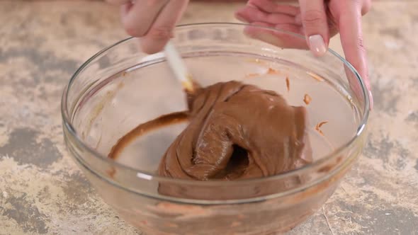 Mixing ingredients to make chocolate choux pastry at home