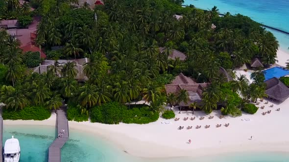 Aerial drone seascape of tourist beach by blue lagoon with sand background