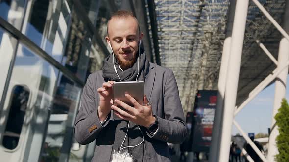 Handsome Businessman Who Using Tablet Computer Near the Modern Business Center