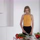 Young Woman Slicing Cucumber For Vegetable Salad. White Modern Kitchen. - VideoHive Item for Sale