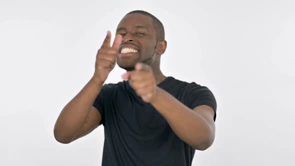 Happy Young African Man Pointing at the Camera on White Background