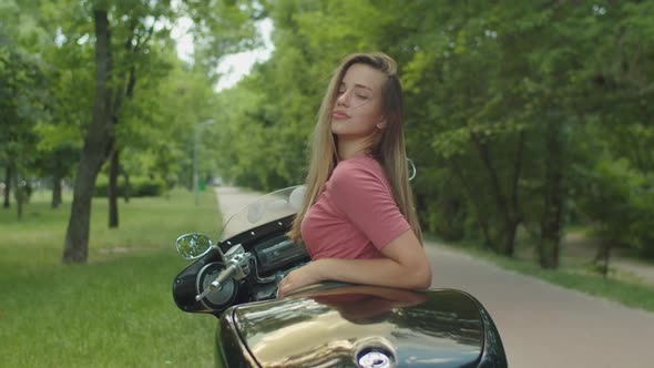 Portrait of Charming Girl Sitting on Motorcycle