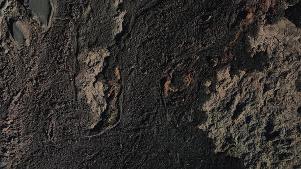 Aerial zenithal view of the volcano's dry lava flows, rifts and cracks. Lunar landscape. Piton de la