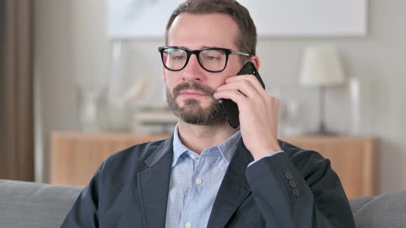 Portrait of Smiling Young Businessman Talking on Smartphone