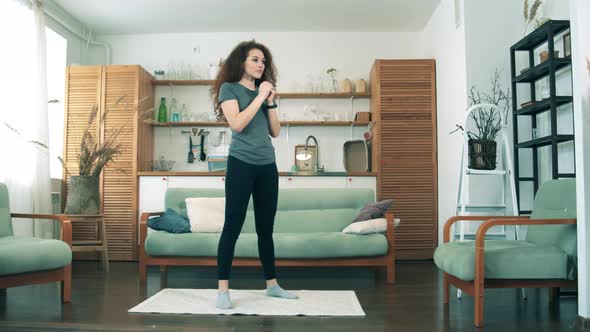 Gorgeous Lady in Self-isolation Is Doing Warm-up Exercises