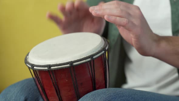 Male Hands Tapping Djembe Bongo in Rhythm