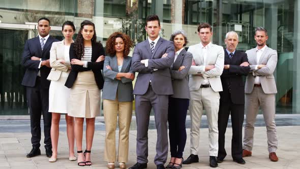 Business people standing with arms crossed in office building