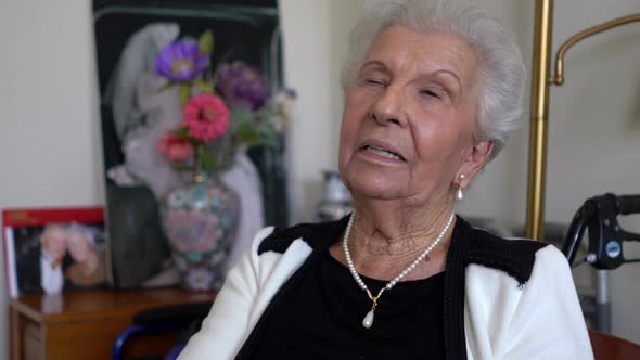 Extreme closeup of elderly woman talking to another woman off camera.