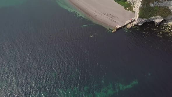 Beautiful revealing shot of Beer, England, Aerial. Ocean, shore, town, countryside.