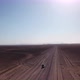 Car Driving on Gravel Road in Aerial Desert - VideoHive Item for Sale
