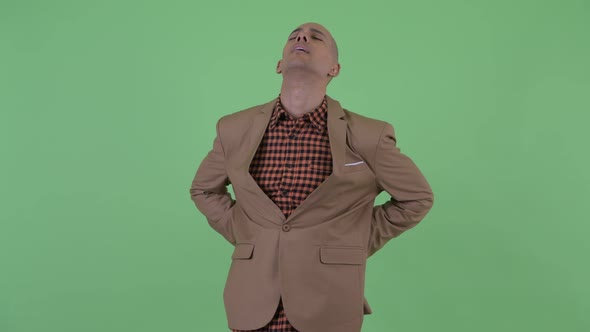 Stressed Bald Multi Ethnic Businessman Having Back Pain