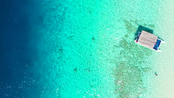 Aerial top view panorama of relaxing seashore beach journey by transparent ocean and bright sandy ba