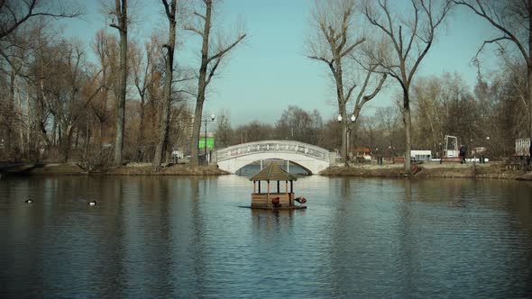 Bird House in the Gorky Park in Moscow, Russia moving around the lake in a time-lapse video. alt
