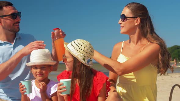 Happy Family Having Picnic on Summer Beach