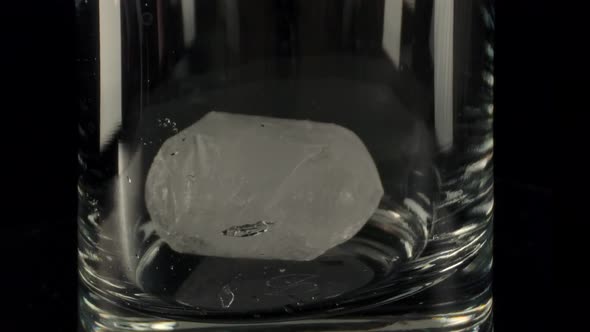 Ice Falling Into Glass Cup
