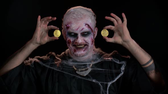 Zombie Man with Makeup with Fake Wounds Scars Showing Golden Bitcoins Mining Btc Cryptocurrency